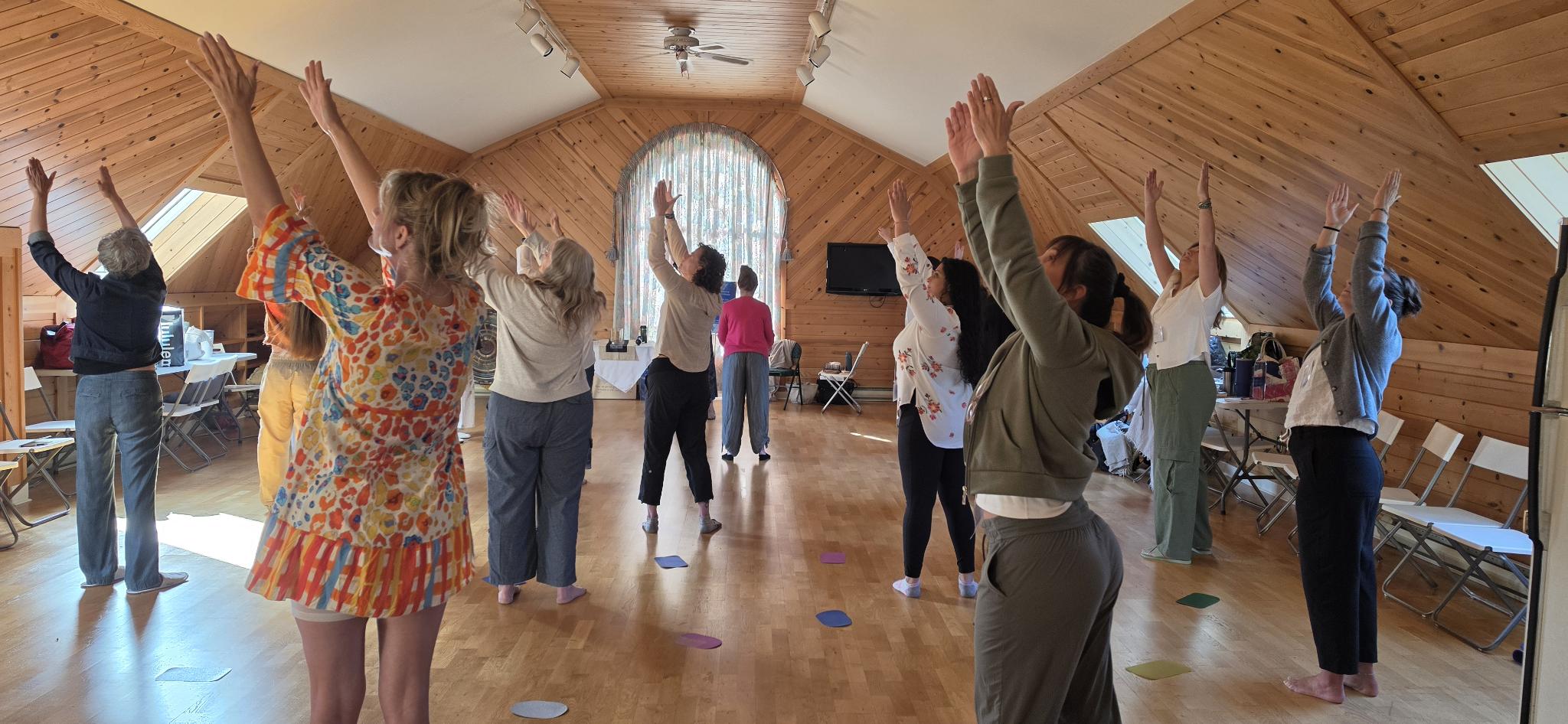 Finding Your Voice workshop participants moving together at Wisteria Acres