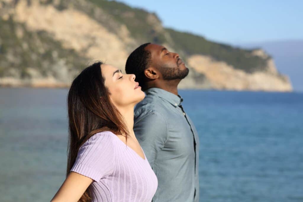 Side,View,Portrait,Of,A,Happy,Interracial,Couple,Breathing,Fresh