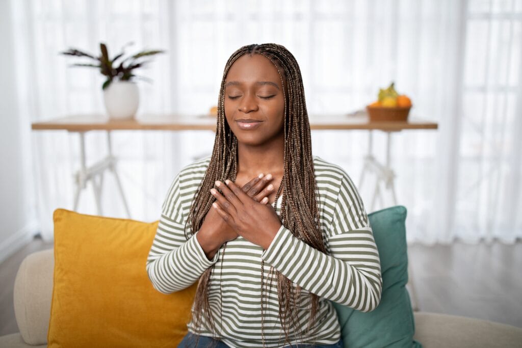 Thankful,Young,Black,Woman,Wearing,Casual,Outfit,Sitting,On,Comfortable
